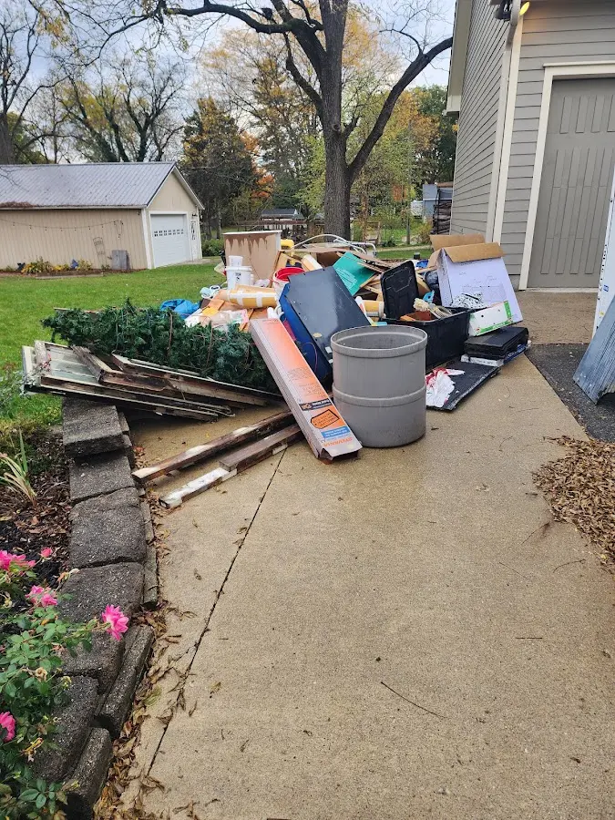 Dumpster being loaded with debris for 12 Yard Dumpster Rental in Nuevo